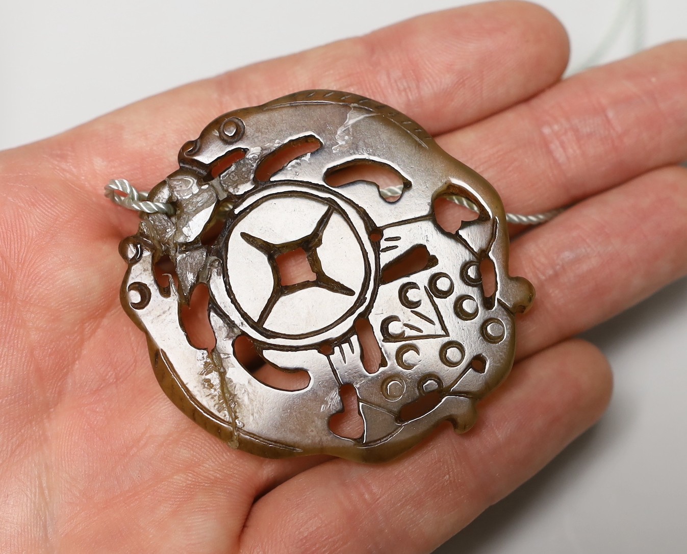 Three Chinese carved hardstone pendants